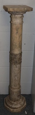 Lot 1116 - A marble torchere carved with a key fret collar, 122cm high