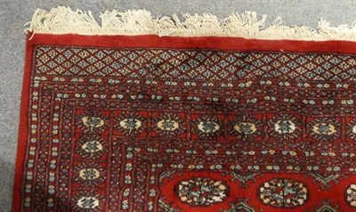 Lot 1122 - A Lahora 'Bukhara' rug , the claret field with rows of guls enclosed by multiple borders, 280cm...