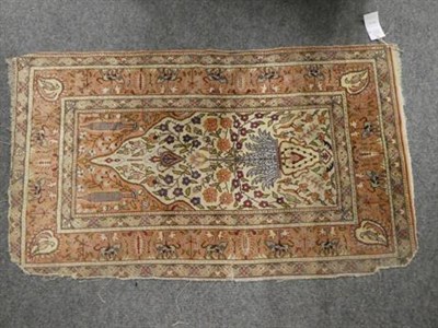 Lot 1123 - Hereke silk Prayer Rug, the field with inscription beneath the Mihrab enclosed by angular vine...