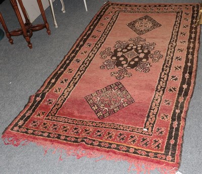 Lot 1129 - Kurdish rug the field of terracotta enclosed by triple borders, 226cm by 124cm