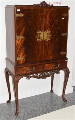 Lot 1131 - A reproduction mahogany cocktail cabinet with mirrored and fitted interior 85cm by 50cm by 159cm
