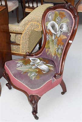Lot 1137 - A Victorian mahogany spoon back nursing chair on cabriole front legs and castors covered in...