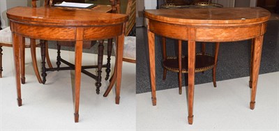 Lot 1141 - A pair of George III satinwood, tulip-wood banded demi-lune fold-over card tables on tapering...