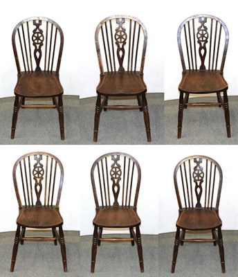 Lot 1157 - A set of six elm Windsor wheel back chairs