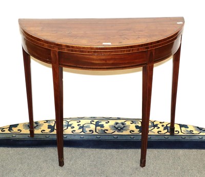 Lot 1165 - A George III cross banded mahogany demi-lune fold over card table 90cm by 44cm by 74cm