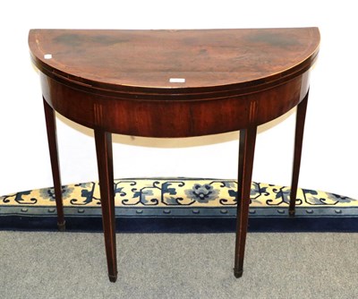 Lot 1167 - A George III inlaid mahogany demi-lune fold over card table 90cm by 44cm by 70cm