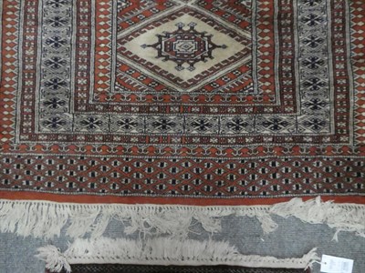 Lot 1168 - Lahore Bukhara rug, the field with a column of salor guls enclosed by multiple borders 160cm by...