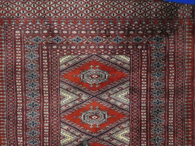 Lot 1168 - Lahore Bukhara rug, the field with a column of salor guls enclosed by multiple borders 160cm by...