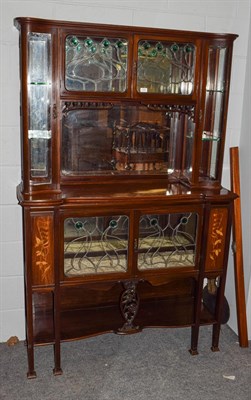 Lot 1181 - An Art Nouveau leaded glazed mahogany inlaid display cabinet, the upper section with two doors...