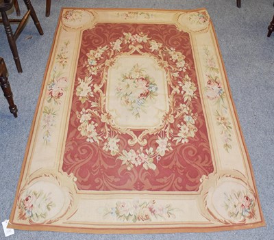 Lot 1186 - A Chinese 'Aubusson' rug, the brick red field of acanthus leaves centred by a floral panel enclosed