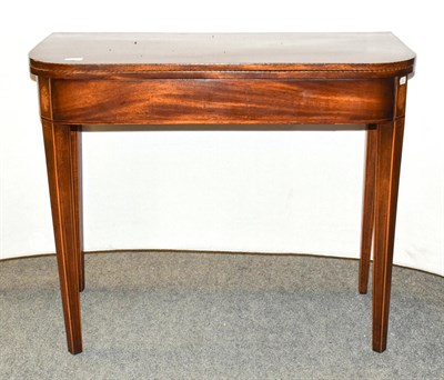Lot 1195 - A George III inlaid mahogany fold over tea table, 90cm by 45cm by 74cm