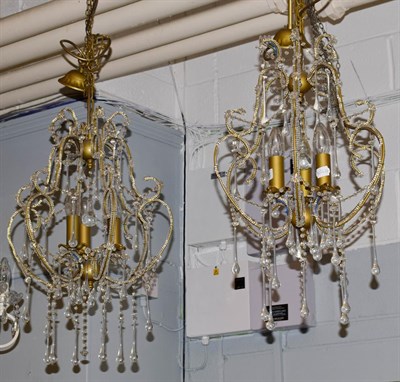 Lot 1219 - A pair of Venetian style three light lustre drop ceiling lights, 60cms drop
