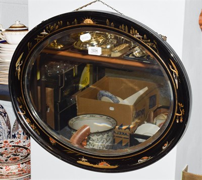 Lot 1224 - An early 20th century oval wall mirror in Japanned frame with bevelled glass, 59cm by 49cm