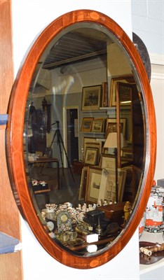 Lot 1225 - A mahogany framed oval wall mirror, with strung and marquetry inlays, 82cm by 57cm