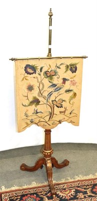 Lot 1240 - A 19th century pole screen with brass pole stand on carved and gilded tripod legs with a crewel...