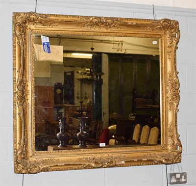 Lot 1247 - A 19th century gilt composition mirror frame with later plate, 119cm by 106cm