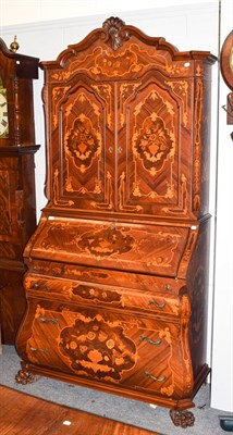 Lot 1250 - A reproduction Continental marquetry bureau bookcase of bombe form raised on massive paw feet,...