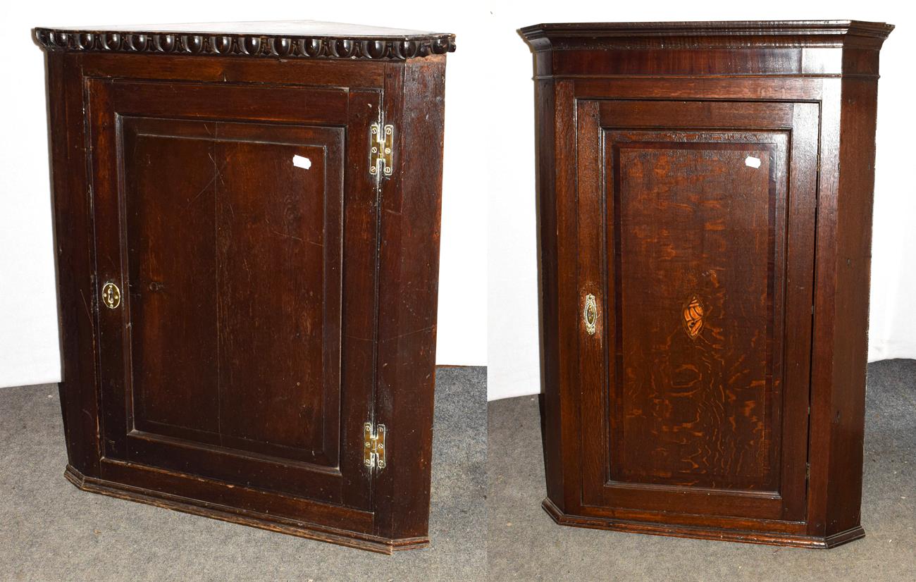 Lot 1253 - A George III oak panelled hanging corner cupboard 75cm by 42cm by 87cm, together with a George...