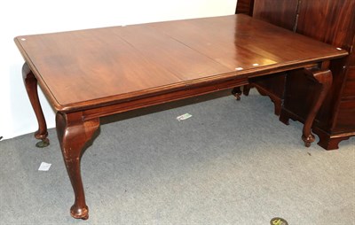 Lot 1255 - An early 20th century mahogany wind out dining table with two additional leaves, 179cm by 106cm...