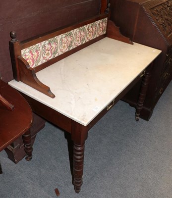 Lot 1282 - An Edwardian marble topped mahogany washstand with tiled splash back, 107cm by 52cm by 103cm