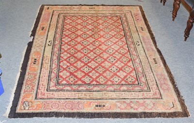 Lot 1170 - Tibetan Rug, the faded strawberry lattice field enclosed by triple borders, 207cm by 153cm