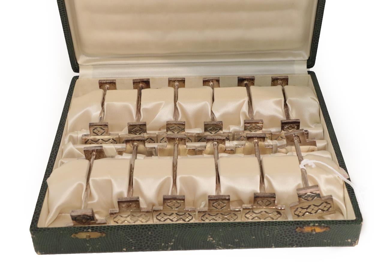 Lot 20 - A Cased Set of Twelve French Silver Plate Knife-Rests, each in the Art-Deco style, with angular...