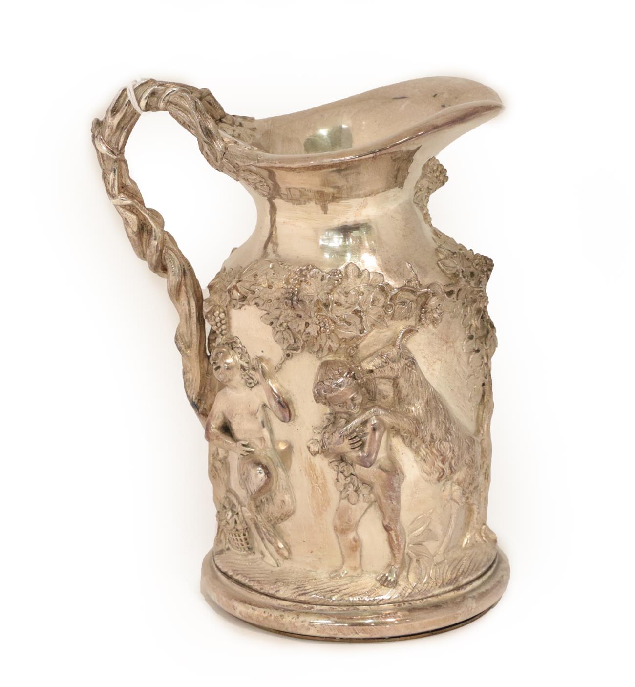 Lot 24 - A Silvered Wine Jug, in the Regency style, heavily cast with Bacchic putto among fruiting...