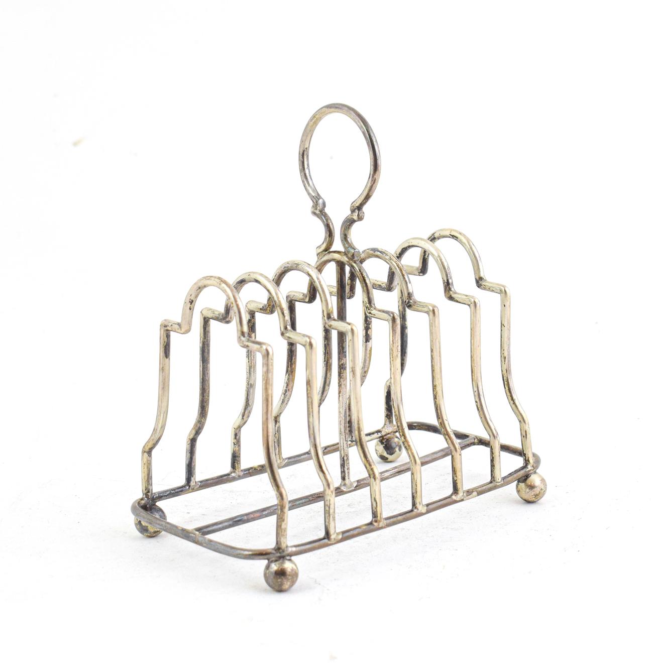 Lot 60 - An Edward VII Silver Toast rack, by William Aitken, Birmingham, 1902, oblong and on four ball feet