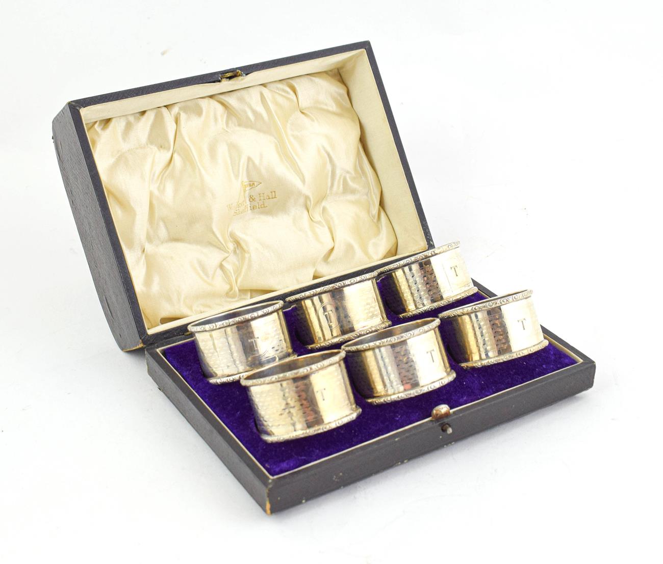Lot 86 - A Cased Set of Six Napkin Rings Four by Henry Matthews, Birmingam, 1918 and 1919, one by Walker and
