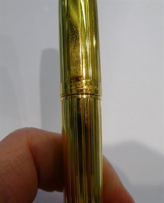 Lot 124 - A Dupont gilt-metal ballpoint pen, with refill; a Sheaffer Australia fountain-pen; a chromed pencil