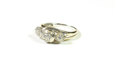 Lot 138 - A 9 carat white gold triple diamond cluster ring, finger size K1/2