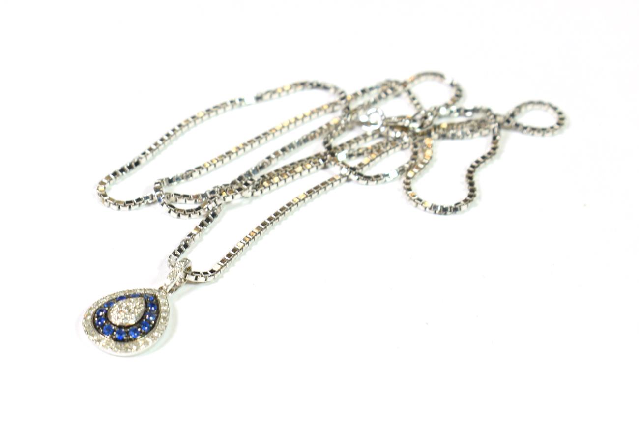 Lot 146 - A sapphire and diamond cluster pendant on an 18 carat white gold chain, chain length 51.5cm