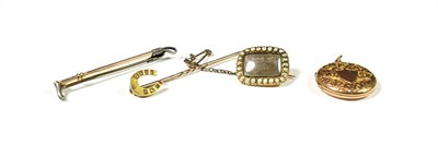 Lot 174 - A 9 carat gold circular engraved locket, length 2.9cm; a diamond set horseshoe stickpin; a...