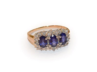 Lot 176 - A 9 carat gold sapphire and diamond cluster ring, three oval sapphires within a border of eight-cut