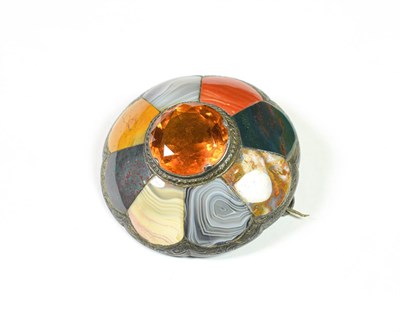 Lot 185 - A Scottish hard stone brooch with a round cut citrine centrally, measures 5.1cm diameter