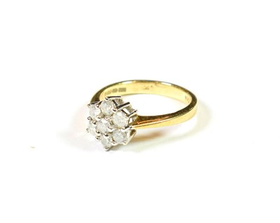 Lot 192 - An 18 carat gold diamond cluster ring, the central raised round brilliant cut diamond within a...