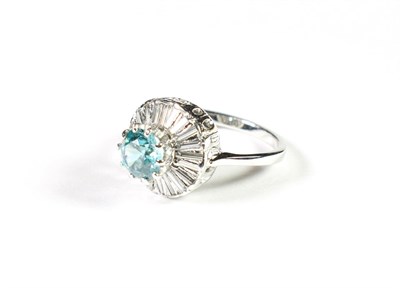Lot 194 - A blue zircon and diamond cluster ring, the round cut blue zircon within a border of baguette...