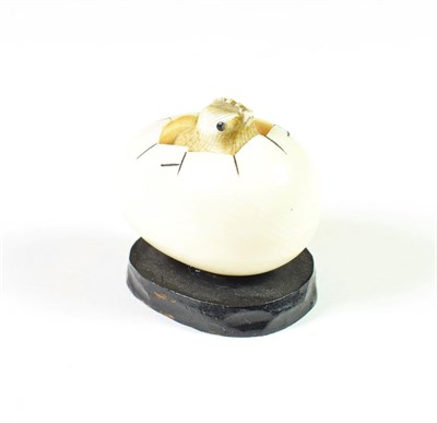 Lot 202 - A Japanese meiji period carved ivory netsuke formed a chick hatching from an egg, signed and...
