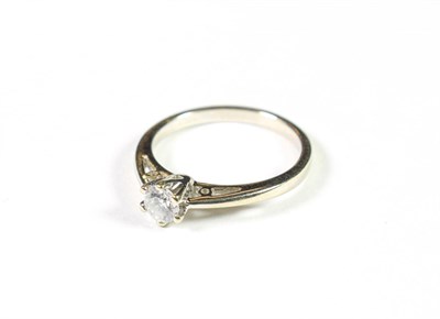 Lot 206 - A diamond solitaire ring, the round brilliant cut diamond in a white claw setting, to a tapered...