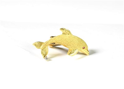 Lot 208 - A synthetic ruby and diamond dolphin brooch, the realistically modelled dolphin with a yellow...