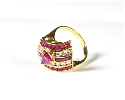 Lot 211 - A synthetic ruby and diamond ring, a pear cut synthetic ruby set above five rows of alternating...