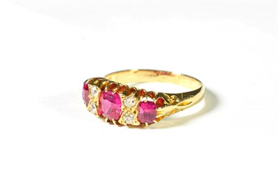 Lot 212 - A synthetic ruby and diamond ring, three graduated oval cut synthetic rubies alternate with...