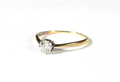 Lot 213 - A diamond solitaire ring, the round brilliant cut diamond in a white claw setting, to a yellow...