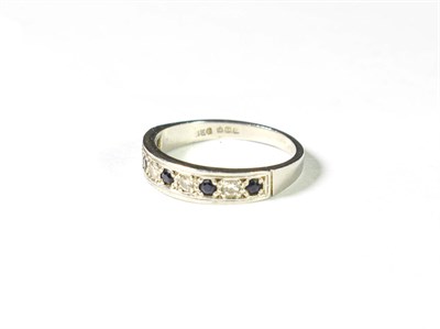 Lot 214 - A platinum sapphire and diamond half hoop ring, five round cut sapphires alternate with four...