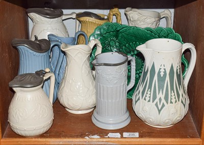 Lot 235 - A quantity of Victorian coloured stoneware jugs with moulded decoration, together with a...