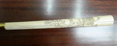 Lot 261 - A Japanese ivory mounted Bamboo walking cane, Meiji period, the handle carved in low relief...