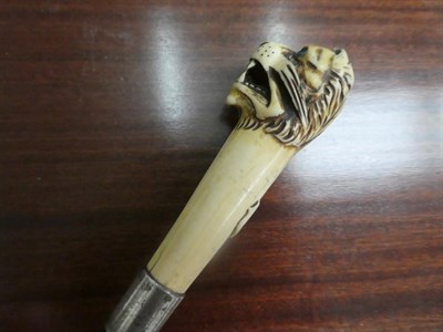 Lot 264 - An ivory mounted walking stick, circa 1900, the handle carved as a Tiger with monogram, white metal