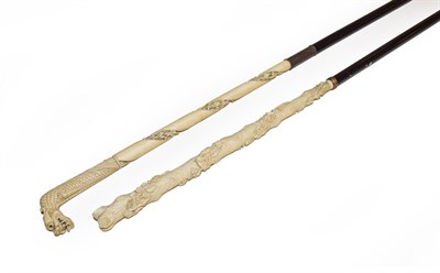 Lot 266 - A Cantonese ivory parasol handle, late 19th century carved as a dragon, on an ebonised stick...