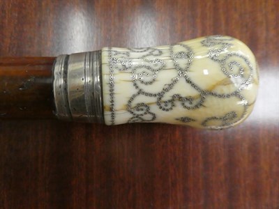 Lot 268 - A ivory and pique mounted malacca walking cane, dated 1700, and initialled I.B with a white...