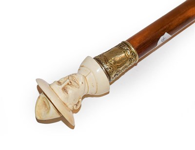 Lot 270 - An ivory mounted malacca walking cane, early 20th century, the handle carved as a bust,...